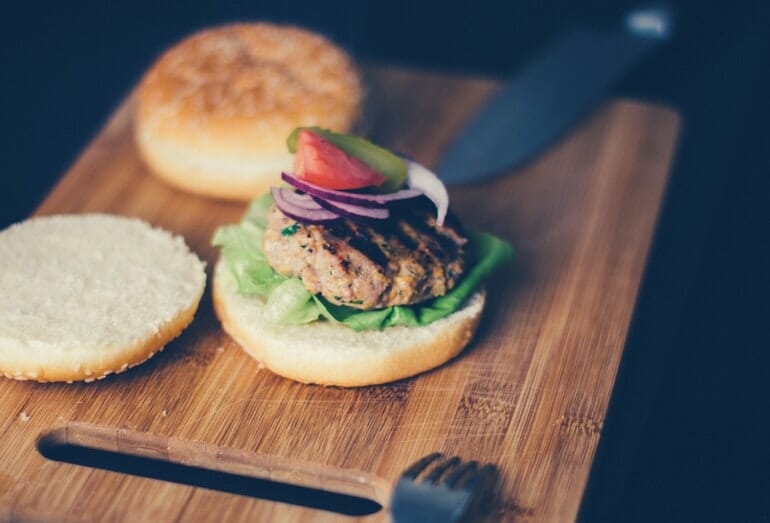 burger-on-real-wood-board-with-knife-scratches.jpeg